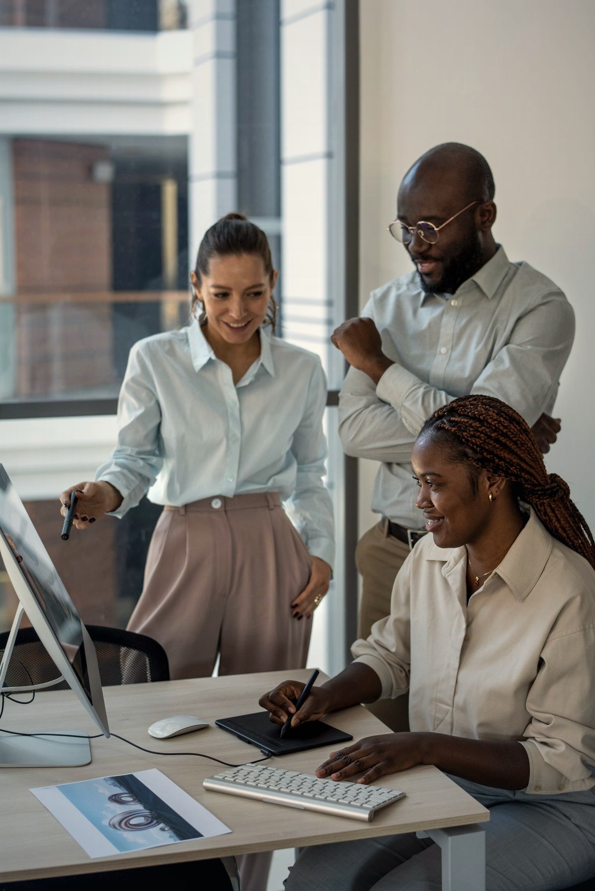 A diverse business team reviewing work together in a modern office
